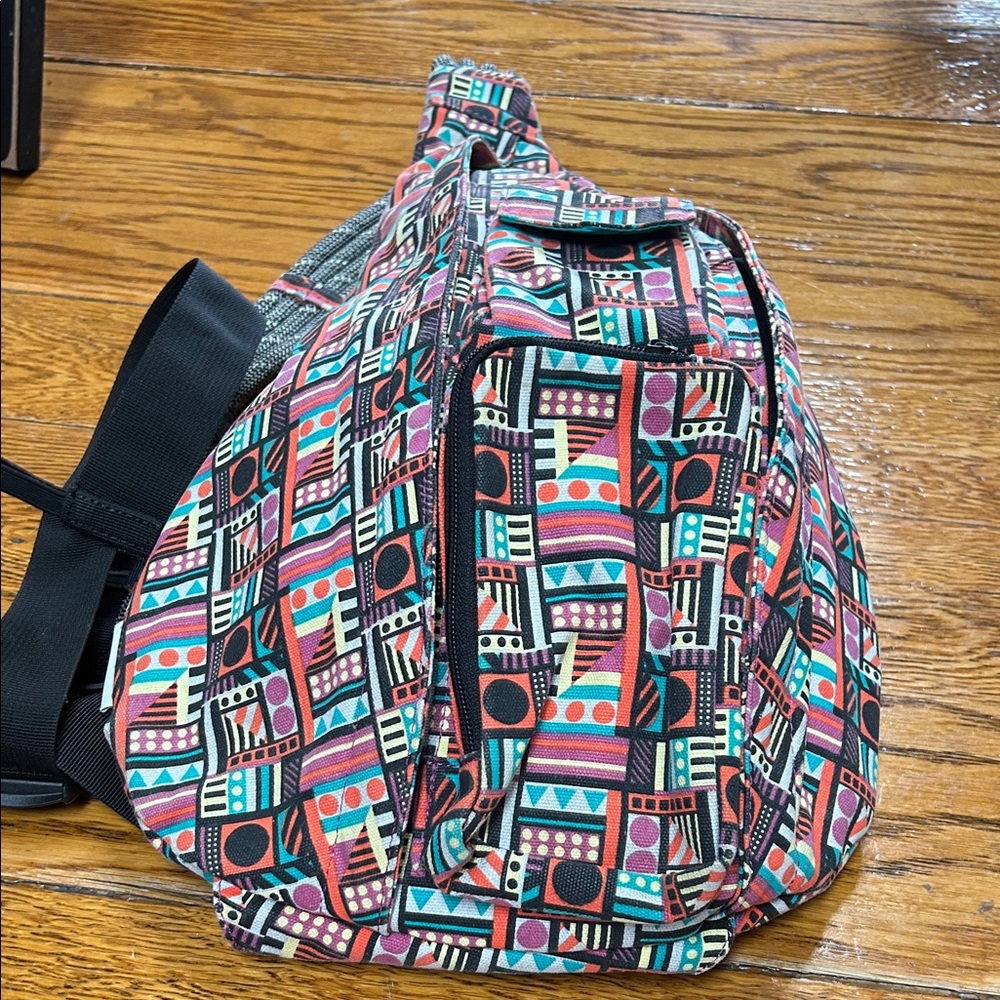 Kavu sling bag backpack in geometric print of Spring Montage.  Good condition.